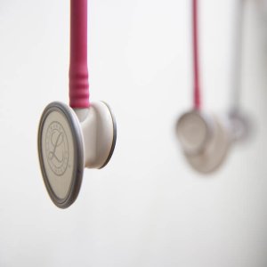 Stethoscopes hanging from wall